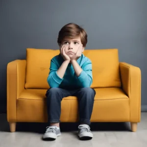 A-child-sitting-on-a-couch-looking-bored